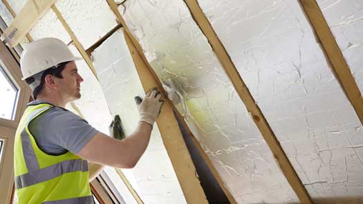 A technician installing insulation in Central FL - Heron Home & Outdoor