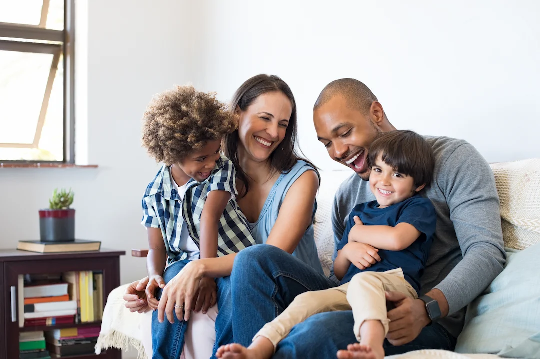 Family sitting on a couch together smiling | Heron Home & Outdoor serving Altamonte Springs, FL