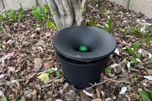 Photo of a Florida residents backyard In2Care installation placed amongst a pile of leaves.