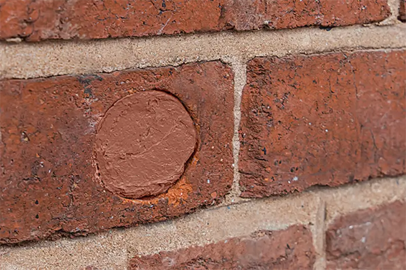 Hole in a brick wall sealed with Flexi Armour